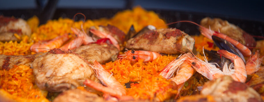 Large photo of paella with shrimp rice roasted chicken and mussels