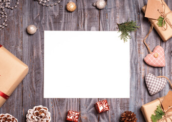 Empty card, Christmas decoration, and gift on wooden background