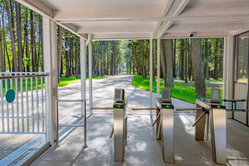 Steel automatic turnstile with arrows for access to the public park