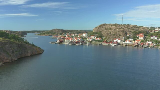 Aerial view flying over the sea toward coastal village