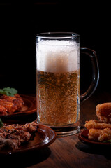 Frothy cool beer with a snack.