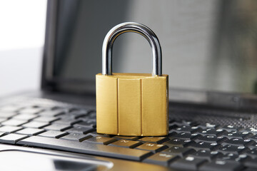 golden padlock on a black laptop keyboard over white background. internet security concept. antivirus software concept. electronic wallet symbol