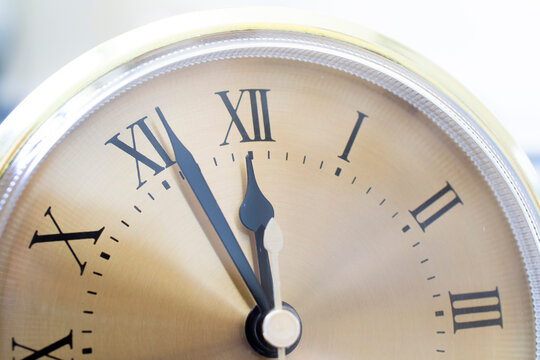 on a clock with Roman numerals from five to twelve. new year new day new life concept