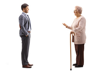 Elderly lady with a walking cane and a young man standing and talking