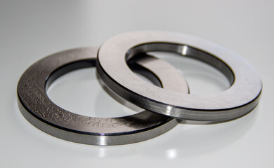 Two outer rings for a thrust roller bearing greased in bearing lubricant with selective focus