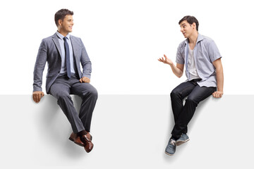 Casual guy talking to a man in a suit and tie and sitting on a panel