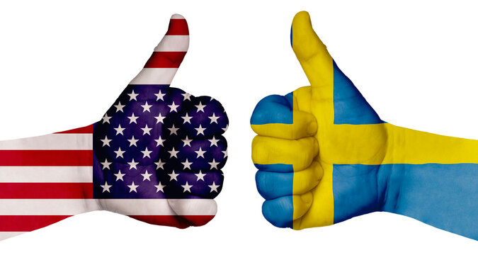 Two hands are painted with flags of different countries, with a thumb raised up. Sweden and the USA