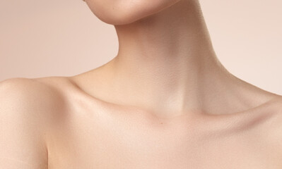 women's neck shoulder lips and collarbone on nude background - obrazy, fototapety, plakaty