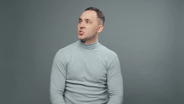 Shooting of young grumbler man in turtleneck