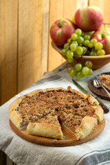 Homemade apple pie with streusel and fresh fruit. Rustic style.