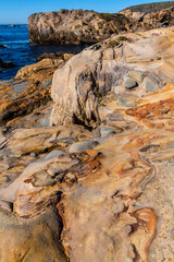Fototapeta na wymiar Abstract Designs Formed in The Sculpted Sandstone Shores of Sand Hill Cove, Point Lobos State Natural Reserve, Big Sur, California, USA