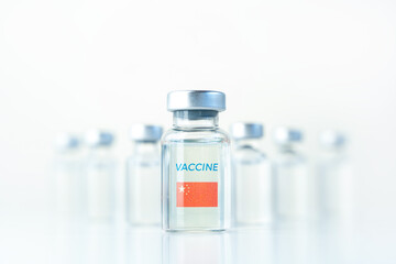 Transparent vials with China flag. Vaccine for covid-19 coronavirus, flu, infectious diseases. Injection after clinical trials for vaccination of human, child, adult, senior. Medicine, drug concept