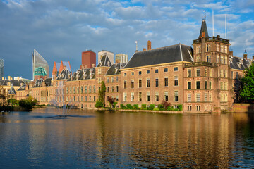 View of the Binnenhof House of Parliament and the Hofvijver lake with downtown skyscrapers in background. The Hague, Netherlands