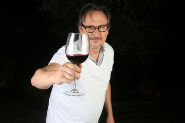 man cheers with a glass of wine