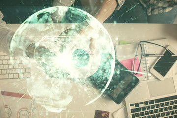 Double exposure of man and woman working together and business theme hologram drawing. Computer background. Top View.