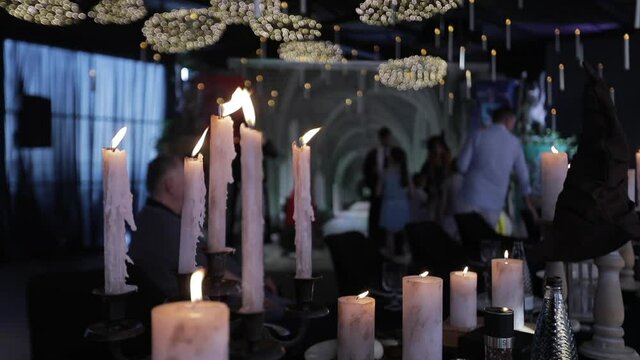 Background of a festive feast with candles on the tables