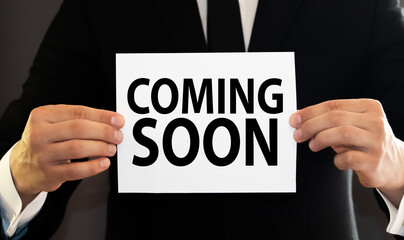 Pen write coming soon word on paper.