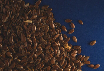 Raw Flax linseed on blue background