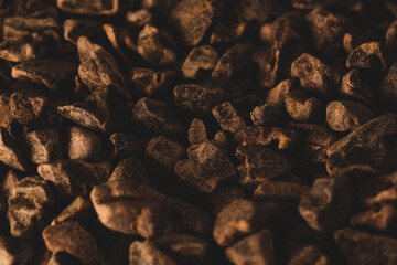 Macro close up picture of Raw Cacao nibs, selective focus