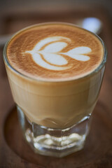   Coffee in classic style with milk and froth in glass