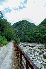 Fototapeta premium Hiking on a discontinued train-line along with Muko river in Hyogo prefecture in Japan