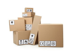 Fototapeta premium Cardboard boxes with different packaging symbols on white background. Parcel delivery