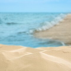 Beautiful beach with golden sand near ocean, closeup view
