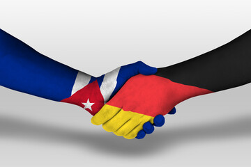 Handshake between germany and cuba flags painted on hands, illustration with clipping path.