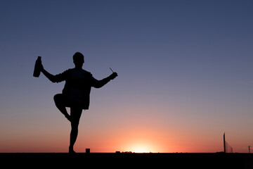 silhouette of a man on a pier at sunset