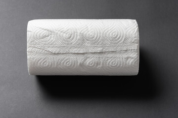 top view brand new paper roll for kitchen on black background