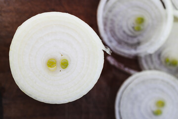 simple food ingredients, fresh onion cut into rings on cutting board