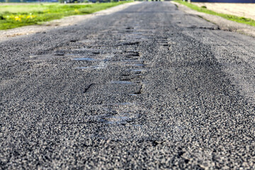 asphalt road that needs repaired