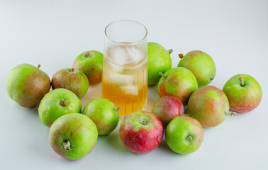 Ripe apples with icy juice on white background, high angle view.