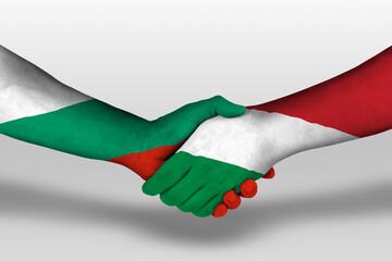 Handshake between hungary and bulgaria flags painted on hands, illustration with clipping path.