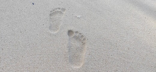 Fototapeta na wymiar footprints in the beach sand
