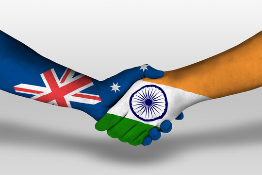 Handshake between india and australia flags painted on hands, illustration with clipping path.