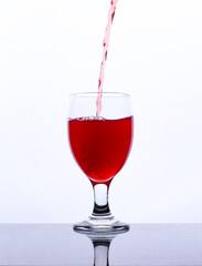 colored drink in a glass isolated white background