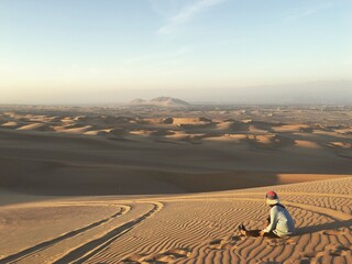 man walking in desert