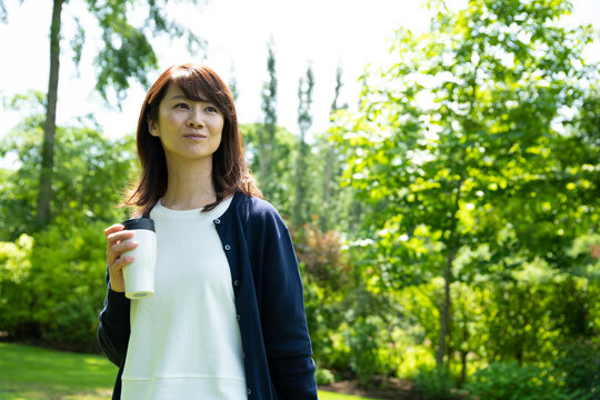 Mature Woman Walking in the Garden