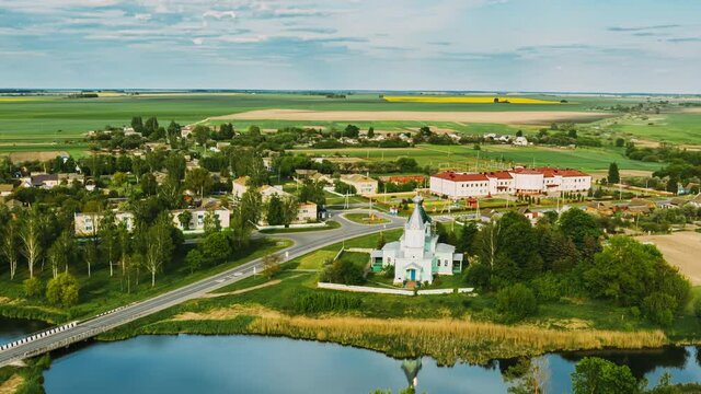 Krupets, Dobrush District, Gomel Region, Belarus. Aerial View Of Old Wooden Orthodox Church Of The Holy Trinity At Sunny Summer Evening. Drone Hyper lapse. 4K