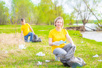 Fototapeta premium Volunteers clear the park from garbage. Volunteer and ecology concept