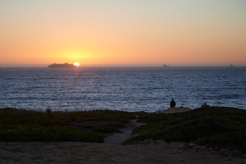 Ship passing in front of the setting sun