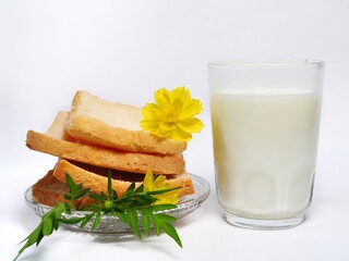 Dry rusk bread and a glass of milk isolated on white background. Healhty breakfast menu