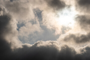 Fototapeta na wymiar sun shines behind thick dark cloud in the morning 