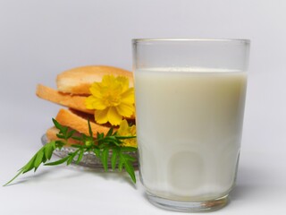 Dry rusk bread and a glass of milk isolated on white background. Healhty breakfast menu