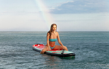 young girl on surfboard . sup 