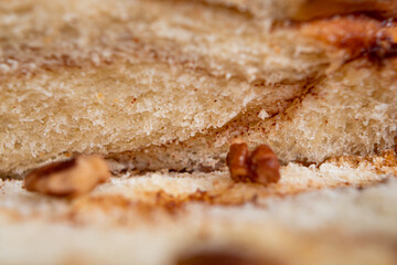 Delicious homemade walnut bread with sliced ​​walnuts pieces in close up.