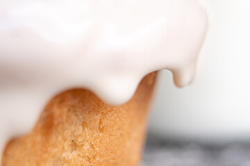 Delicious cinnamon roll covered in white frosting.