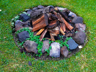 Outdoor fire extinguished covered by vegetation in the outdoor garden.
