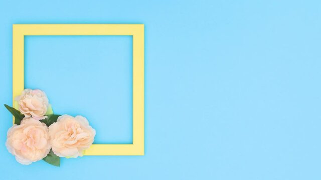 Yellow transparent frame for text appear with flowers on blue theme. Stop motion 